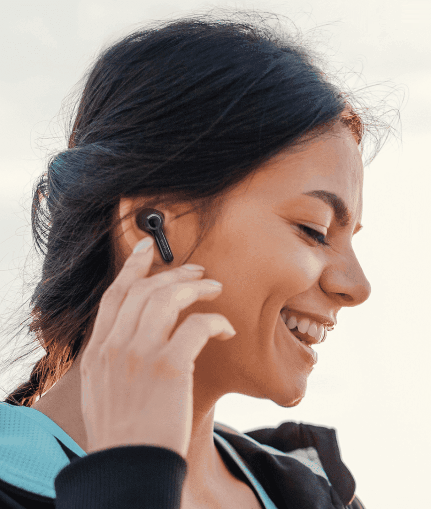 Woman wearing Earfun Air Pro 2 about to use touch touch controls