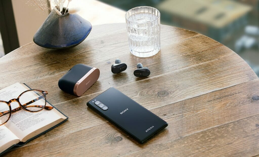 The older Sony WF-1000XM3s out of case next to phone