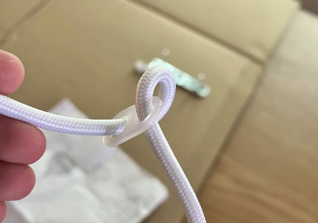 Plastic clip to keep light from putting weight on wire connections