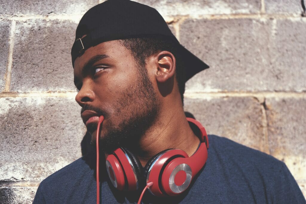 Man with headphones who has short facial hair 