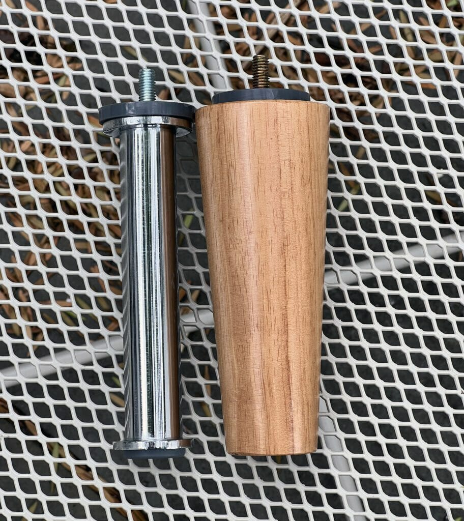 a comparison of the metal leg to the wooden leg, which are similar in length but the wooden one is much thicker